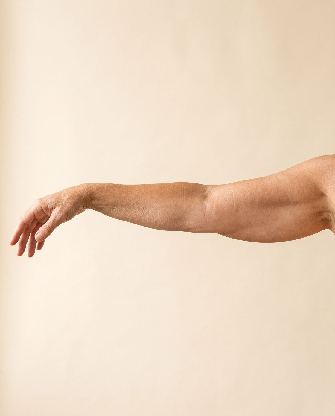 An outstretched arm with soft, natural skin on its underside