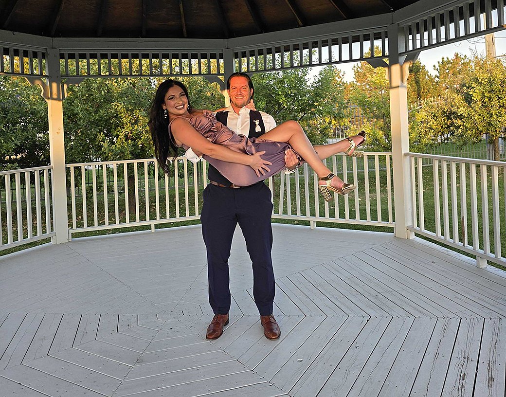 Sandra and Srdjan, the founders of Pielnora, laughing together in a gazebo at golden hour